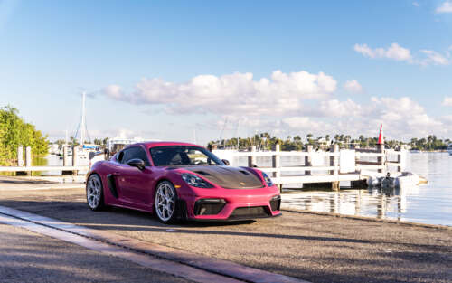 Luksusowy sportowy samochód marki Porsche zaparkowany na nowoczesnej ulicy w mieście... 7680x4800