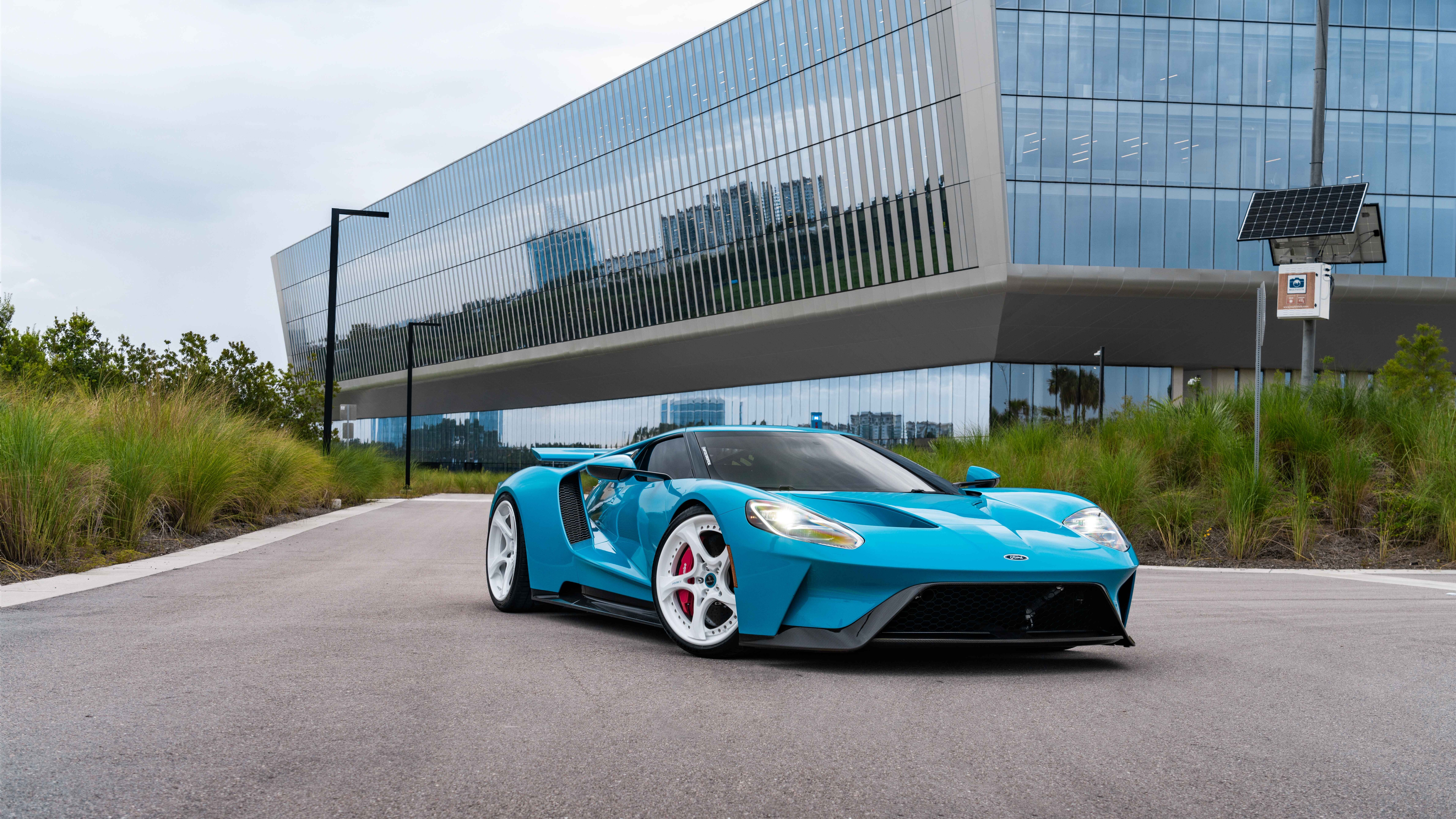 Wysokowydajny samochód sportowy Ford GT, charakteryzujący się charakterystyczną, aerodynamiczną sylwetką i eleganckimi liniami nadwozia.